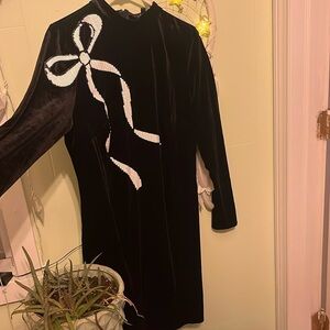 Black velvet mini dress with white sequin bow detail
